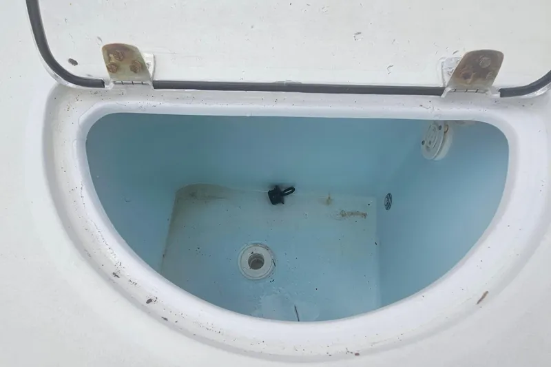 Slide: The Image of Open storage compartment on 2016 Sportsman Heritage 211 Center Console boat. - 18