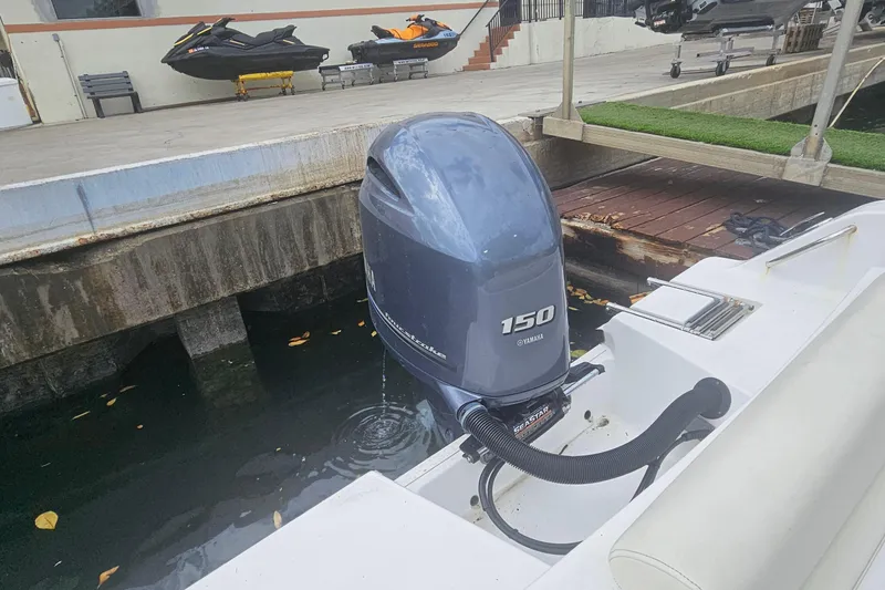 Slide: The Image of 2016 Sportsman Heritage 211 Center Console with Yamaha 150 outboard motor at dock. - 19