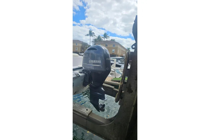 Slide: The Image of 2016 Sportsman Heritage 211 Center Console with Yamaha outboard motor in marina setting. - 21