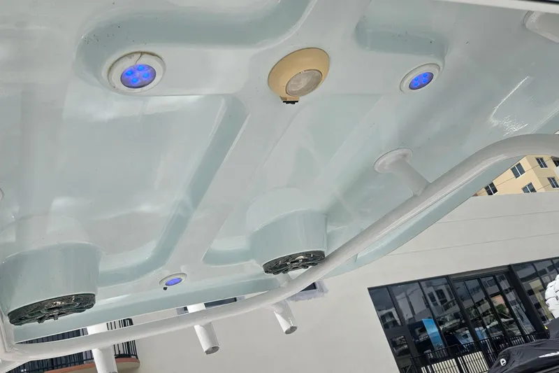 Slide: The Image of 2016 Sportsman Heritage 211 Center Console boat with blue LED lights and speakers. - 7