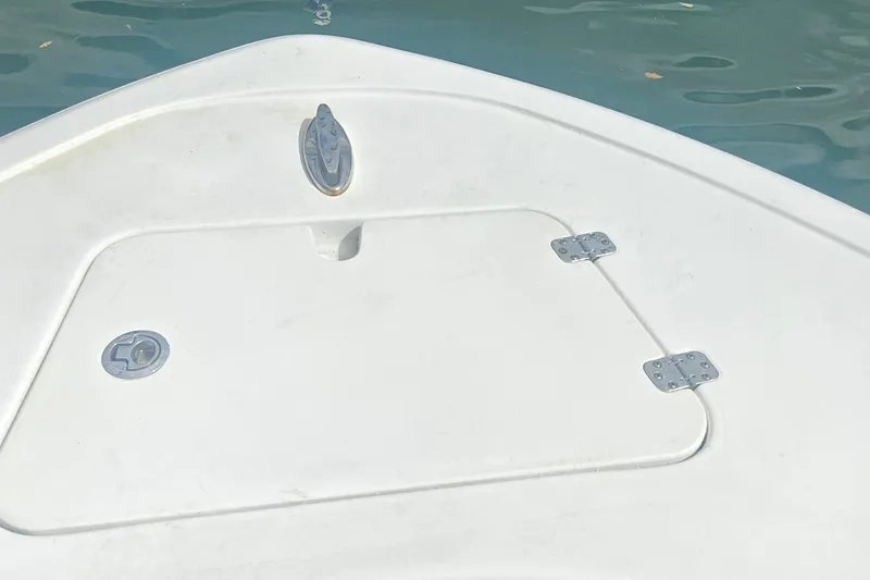 Slide: The Image of 2016 Sportsman Heritage 211 Center Console boat deck with storage hatch. - 8