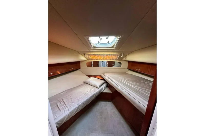 Slide: The Image of 2003 Sea Ray 390 Motor Yacht cabin with twin beds and overhead skylight. - 10