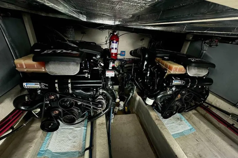 Slide: The Image of Engine room of 2003 Sea Ray 390 Motor Yacht with dual engines and fire extinguisher. - 11
