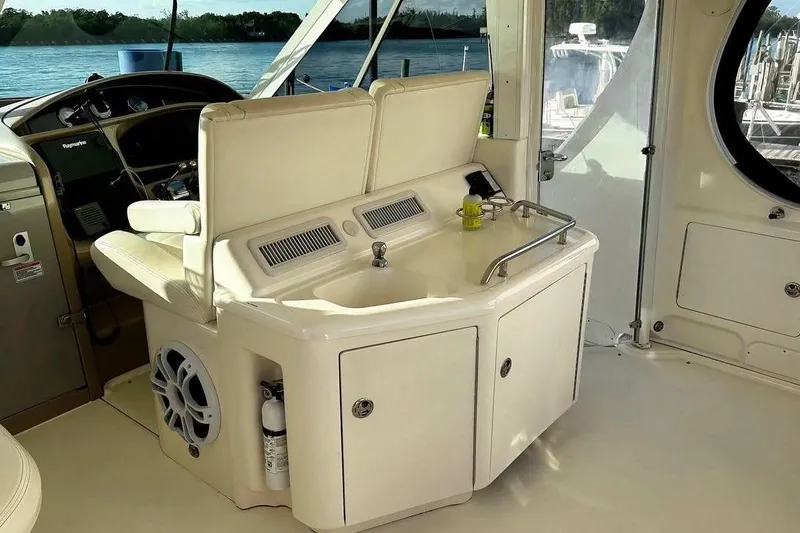 Slide: The Image of 2003 Sea Ray 390 Motor Yacht interior with helm, sink, and seating area. - 5