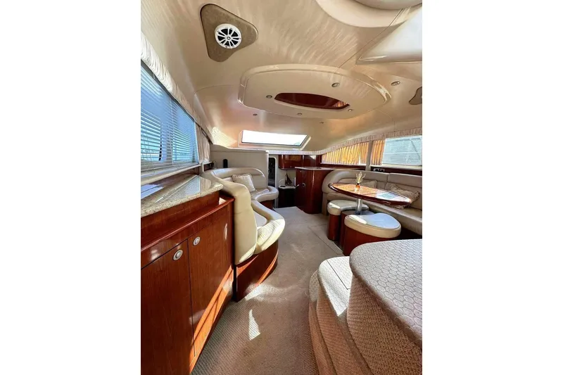 Slide: The Image of Luxurious interior of 2003 Sea Ray 390 Motor Yacht with elegant seating and wood finishes. - 6