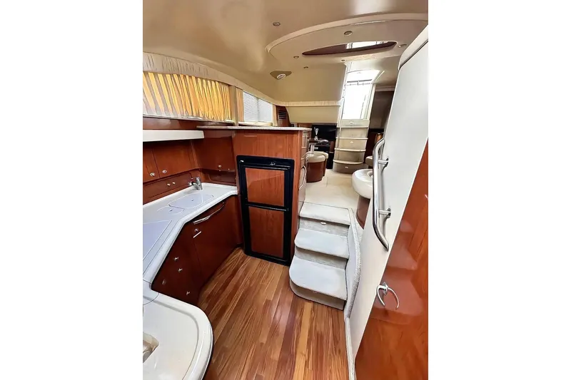 Slide: The Image of 2003 Sea Ray 390 Motor Yacht interior with modern kitchen and elegant wood finishes. - 8