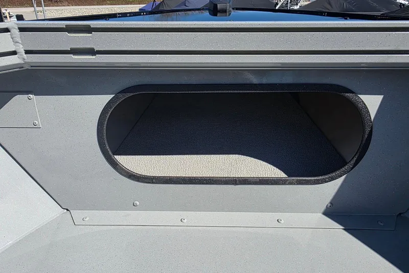 Slide: The Image of Storage compartment in 2026 Smoker Craft Avenger 188 HD Pro boat, featuring a carpeted interior. - 12