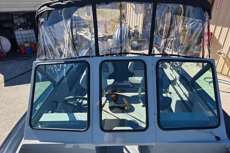 Slide: The Image of 2026 Smoker Craft Avenger 188 HD Pro boat with clear canopy and spacious interior. - 13