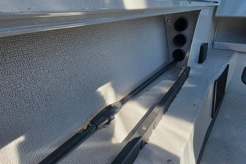 Slide: The Image of 2026 Smoker Craft Avenger 188 HD Pro interior storage compartment with rod holders. - 19