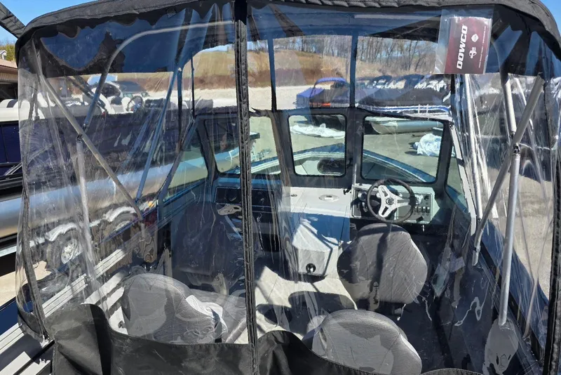 Slide: The Image of 2026 Smoker Craft Avenger 188 HD Pro boat interior with clear canopy and steering wheel. - 6