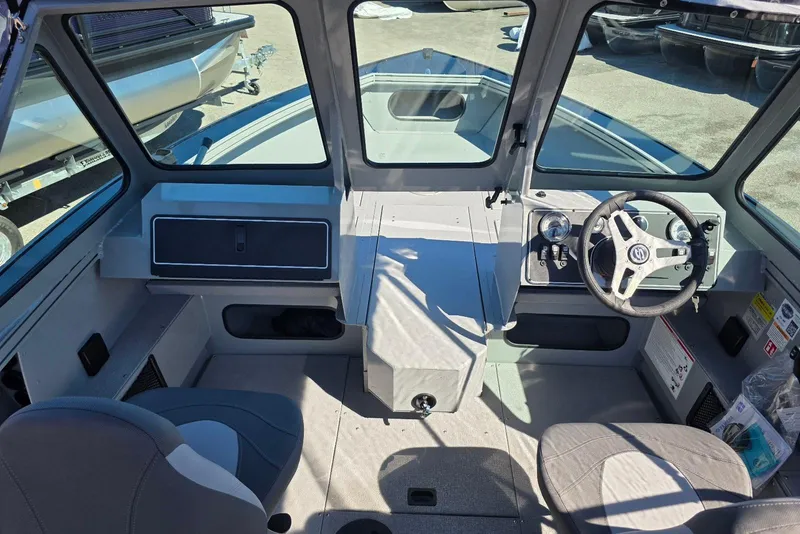 Slide: The Image of 2026 Smoker Craft Avenger 188 HD Pro boat interior with steering wheel and seating. - 7
