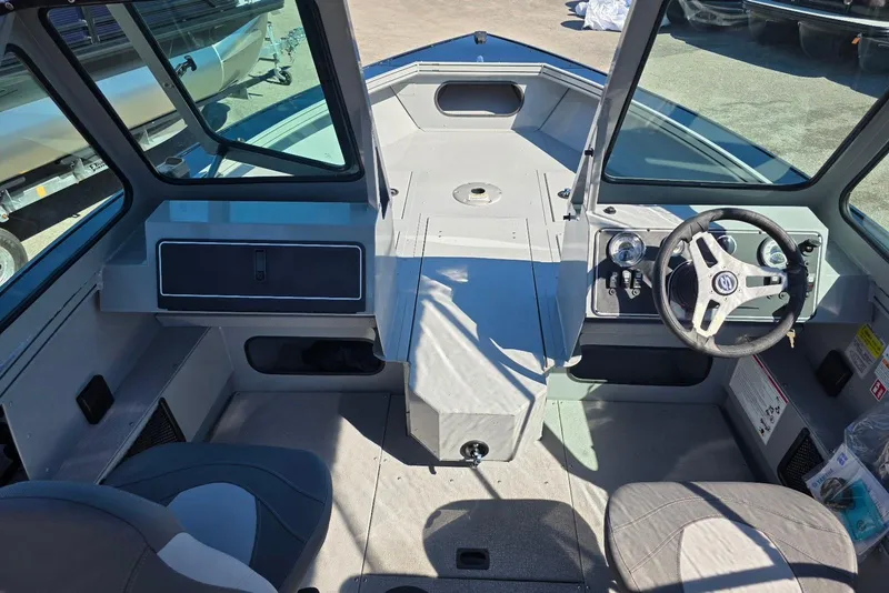 Slide: The Image of 2026 Smoker Craft Avenger 188 HD Pro boat interior with steering wheel and seating. - 8