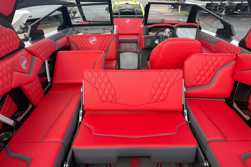 Slide: The Image of 2026 Tigé 24RZX boat interior with luxurious red seating and modern dashboard. - 10