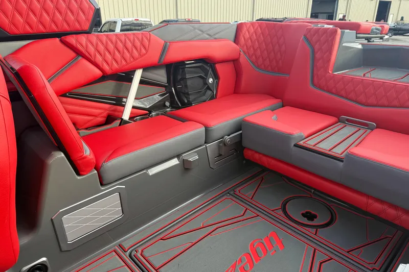 Slide: The Image of 2026 Tigé 24RZX boat interior with red and gray seating, featuring diamond stitching. - 11
