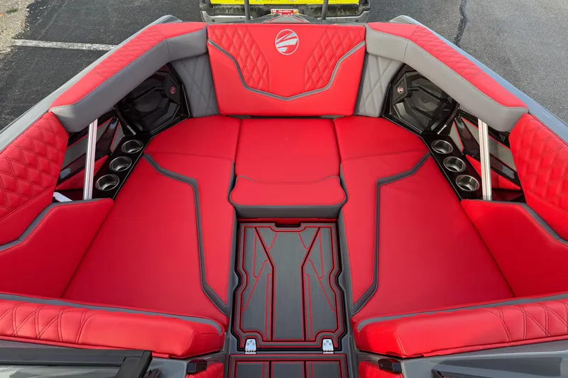 Slide: The Image of 2026 Tigé 24RZX boat interior with red and gray seating, cup holders, and stylish design. - 14