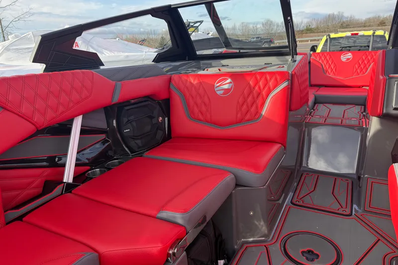 Slide: The Image of 2026 Tigé 24RZX boat interior with red and gray seating, featuring modern design elements. - 16