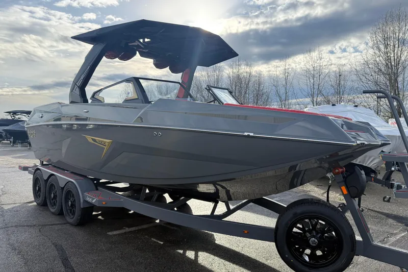 Slide: The Image of 2026 Tigé 24RZX boat on trailer under cloudy sky, showcasing sleek design. - 4