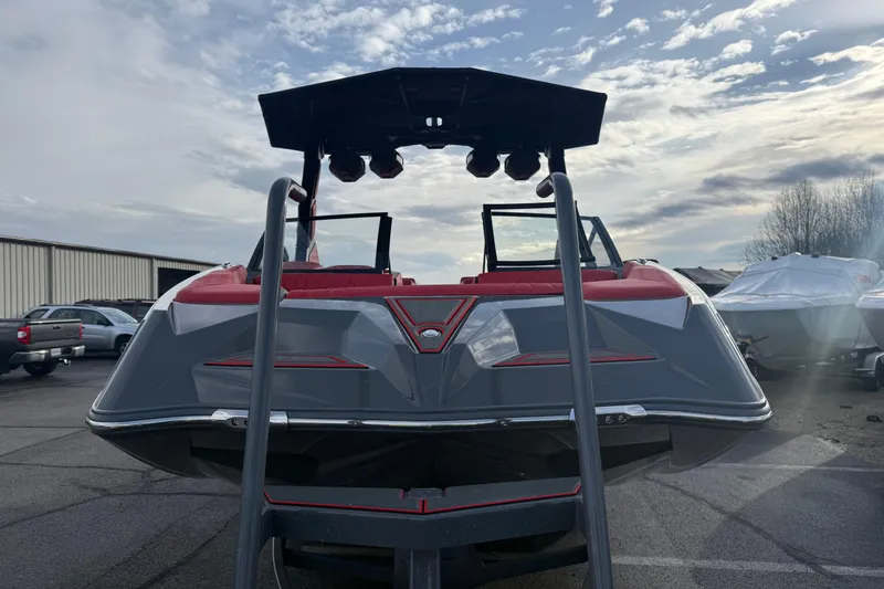 Slide: The Image of 2026 Tigé 24RZX boat with sleek design, red and gray accents, parked outdoors. - 5