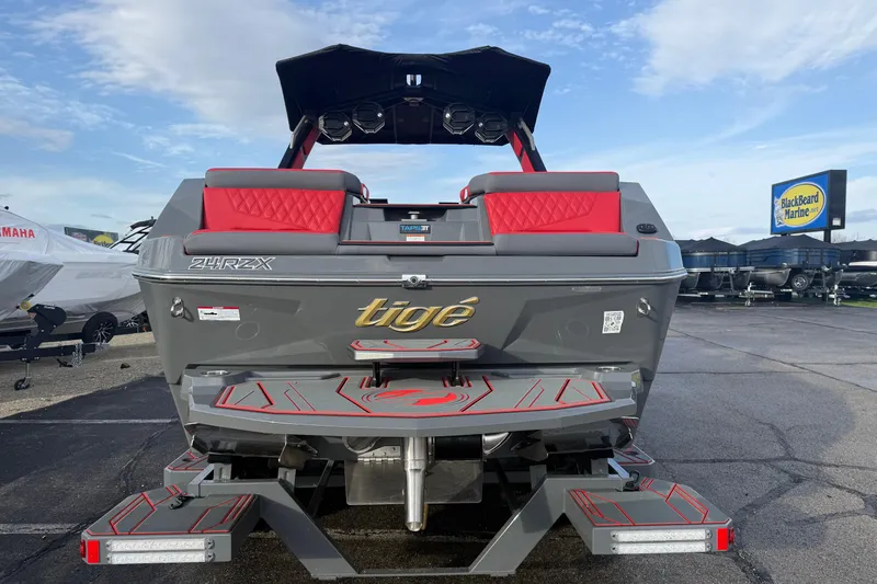 Slide: The Image of 2026 Tigé 24RZX boat with red accents, displayed at Blackbeard Marine dealership. - 7