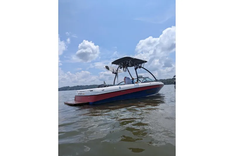 The Image of 2003 Malibu Wakesetter 23 LSV boat on a calm lake under a cloudy sky. - 1