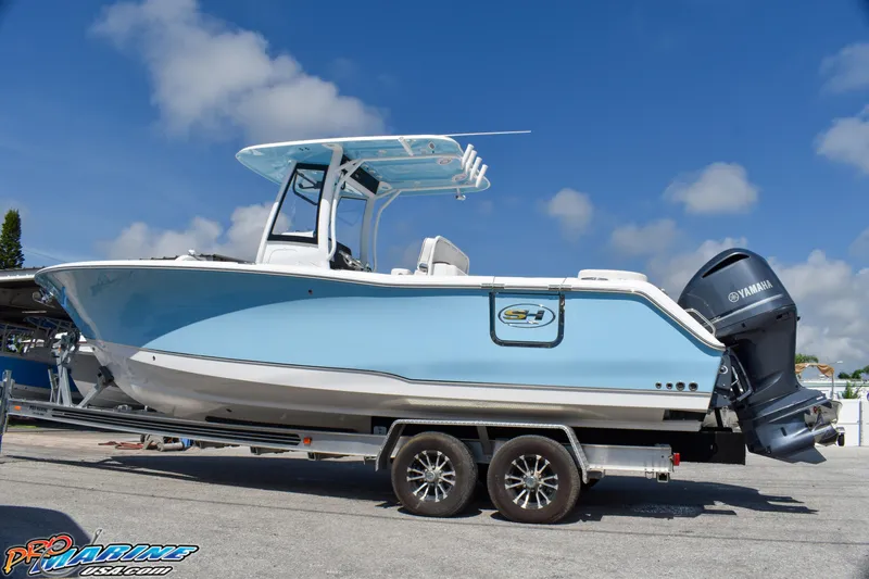 The Image of 2019 Sea Hunt Ultra 275 SE boat on trailer, blue sky. - 0