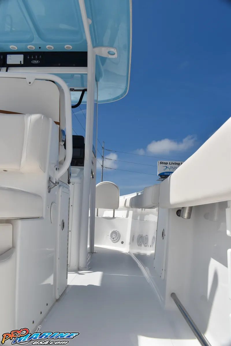 Slide: The Image of Sea Hunt Ultra 275 SE 2019, boat canopy and seating area, blue sky. - 26
