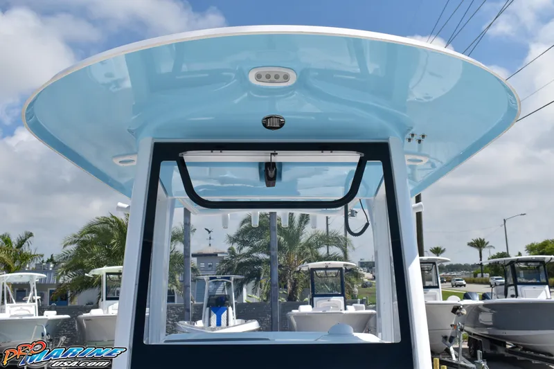 Slide: The Image of 2019 Sea Hunt Ultra 275 SE boat with blue canopy. - 32
