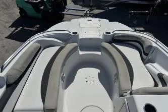 Slide: The Image of 2017 Starcraft 2000 OB Limited boat interior with cushioned seating and storage compartments. - 12