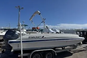 Slide: The Image of 2017 Starcraft 2000 OB Limited boat on trailer under clear blue sky. - 3