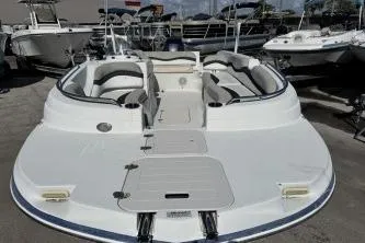 Slide: The Image of 2017 Starcraft 2000 OB Limited boat, white exterior, docked among other boats. - 5