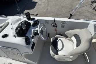 Slide: The Image of 2017 Starcraft 2000 OB Limited boat cockpit with steering wheel and control panel. - 8