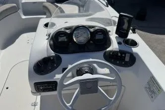 Slide: The Image of 2017 Starcraft 2000 OB Limited boat dashboard with steering wheel and gauges. - 9