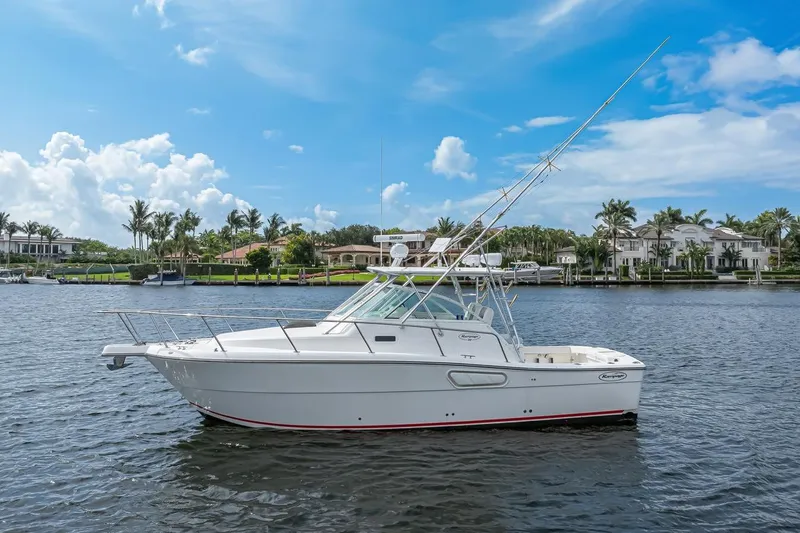 The Image of 2000 Rampage 30 Express boat on calm water with luxury homes in the background. - 0