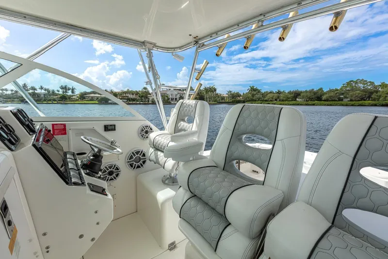 Slide: The Image of Interior of 2000 Rampage 30 Express boat with luxurious seating and scenic water view. - 11