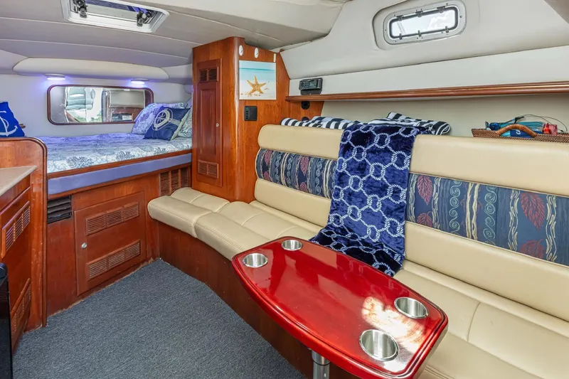 Slide: The Image of Interior of 2000 Rampage 30 Express boat with cozy seating and bed area. - 15