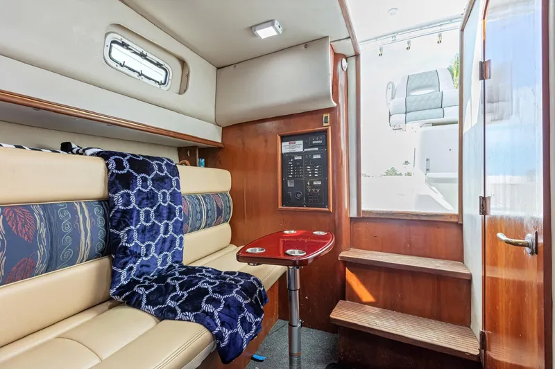 Slide: The Image of Interior of 2000 Rampage 30 Express boat with cozy seating and wooden accents. - 17