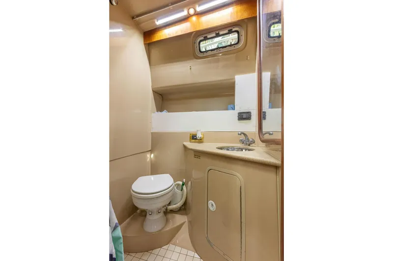 Slide: The Image of Bathroom interior of 2000 Rampage 30 Express boat, featuring toilet and sink. - 18