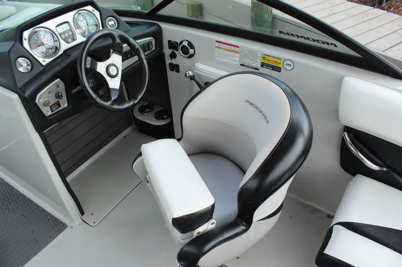 Slide: The Image of 2012 Moomba Mojo 2.5 boat interior with steering wheel and captain's chair. - 12