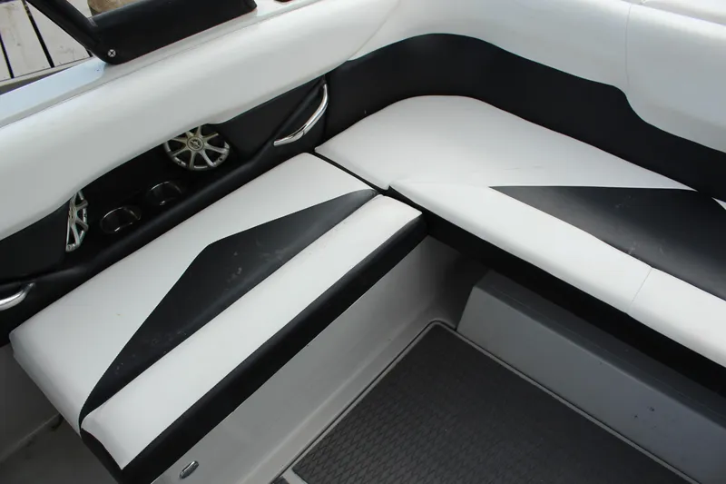 Slide: The Image of 2012 Moomba Mojo 2.5 boat interior with black and white seating and speaker system. - 17