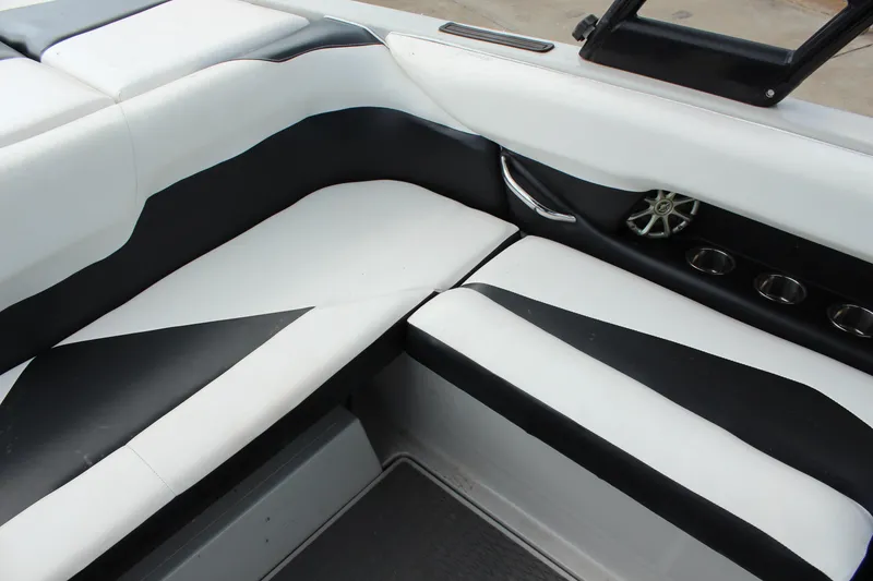 Slide: The Image of 2012 Moomba Mojo 2.5 boat interior with black and white seating and cup holders. - 18