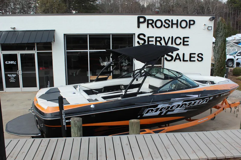 Slide: The Image of 2012 Moomba Mojo 2.5 boat displayed outside a pro shop service and sales center. - 3