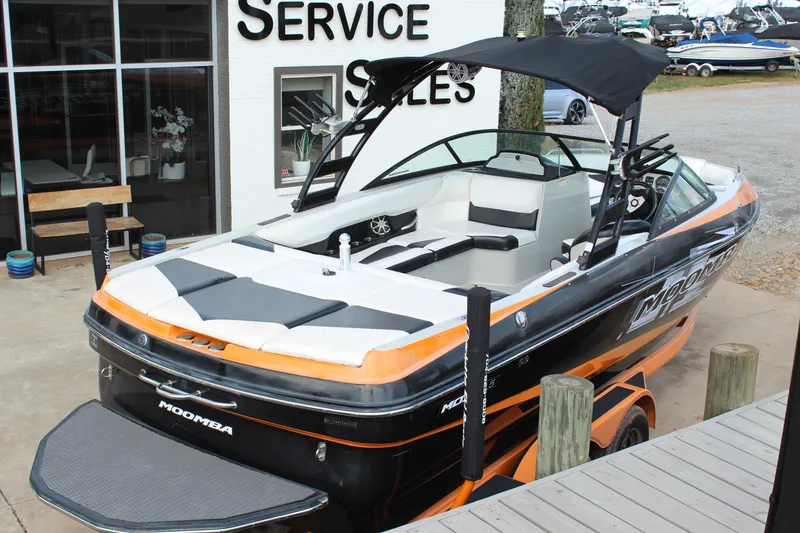 Slide: The Image of 2012 Moomba Mojo 2.5 boat at service sales, black and orange design. - 4