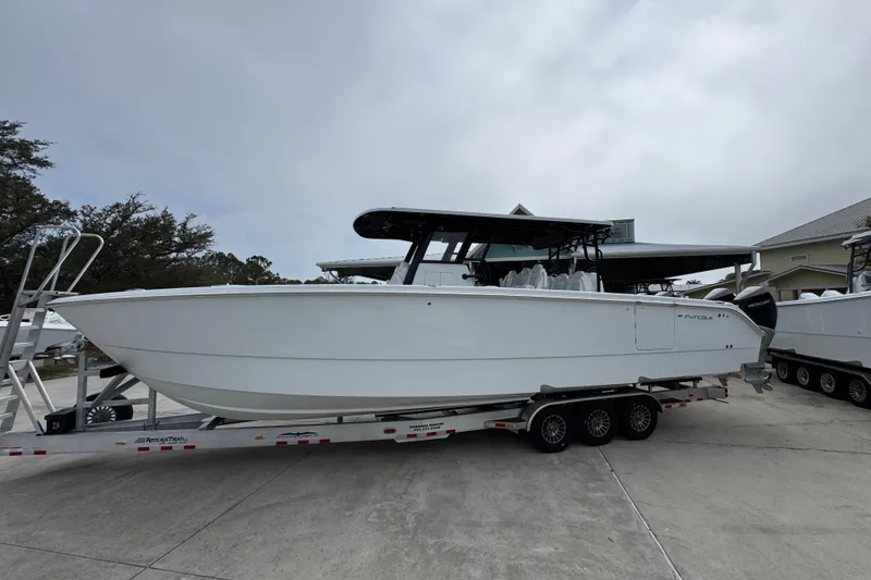 The Image of 2026 Invincible 38 Catamaran on trailer, sleek design, parked outdoors. - 1