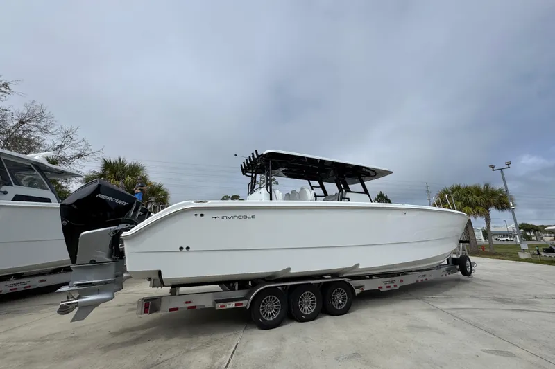 Slide: The Image of 2026 Invincible 38 Catamaran on trailer, side view, with Mercury engines. - 11