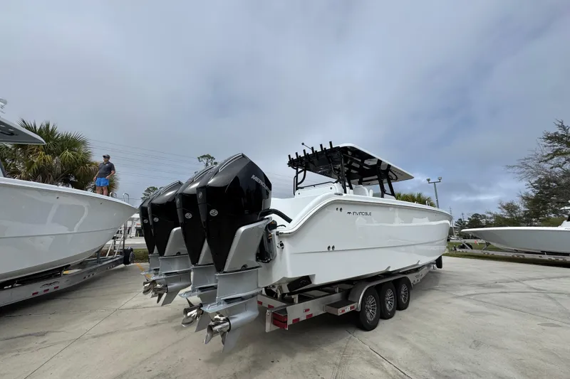 Slide: The Image of 2026 Invincible 38 Catamaran with triple outboard engines on a trailer. - 12