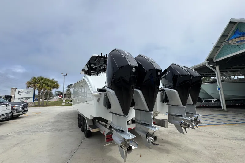 Slide: The Image of 2026 Invincible 38 Catamaran with four powerful outboard engines at a marina. - 15