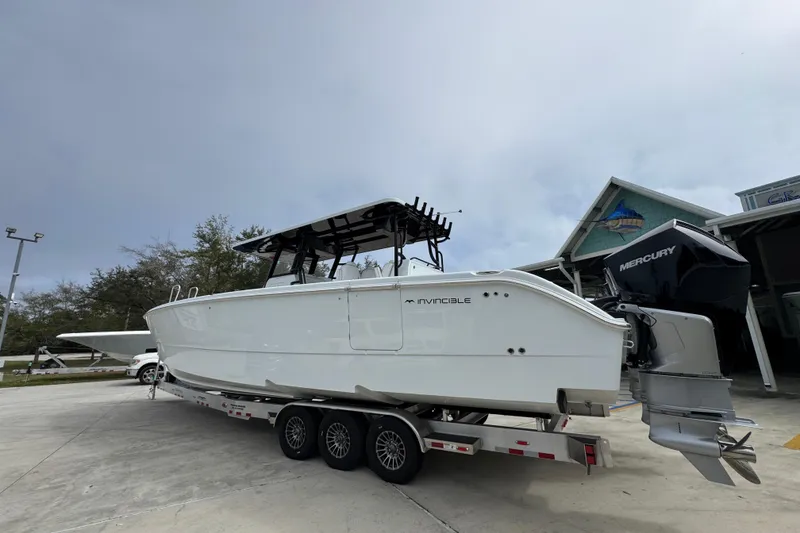 Slide: The Image of 2026 Invincible 38 Catamaran on trailer, featuring Mercury outboard engines. - 17
