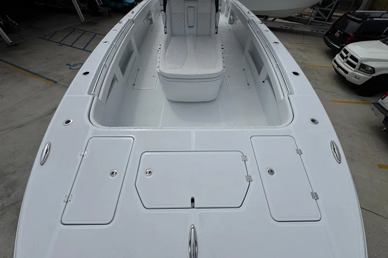 Slide: The Image of 2026 Invincible 38 Catamaran deck view with seating and storage compartments. - 18