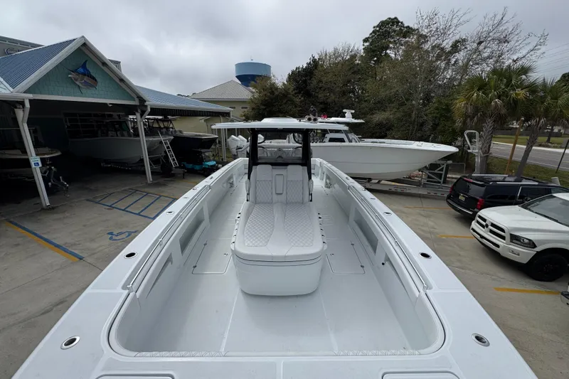 Slide: The Image of 2026 Invincible 38 Catamaran docked at a marina, showcasing spacious deck and sleek design. - 19