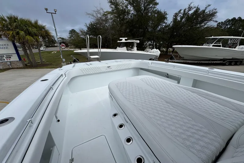 Slide: The Image of 2026 Invincible 38 Catamaran with spacious deck and seating, displayed outdoors. - 23